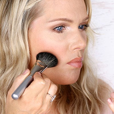 Suck in cheeks & place brush in the hollow created