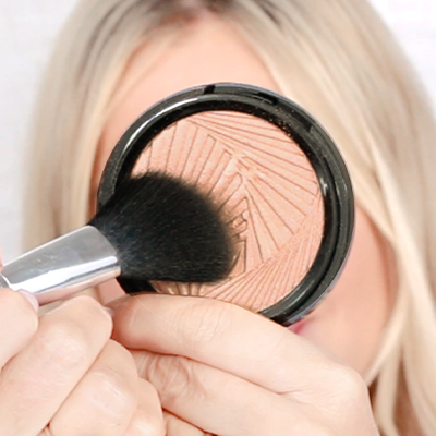 Swirl a blush brush into the powder & tap off excess